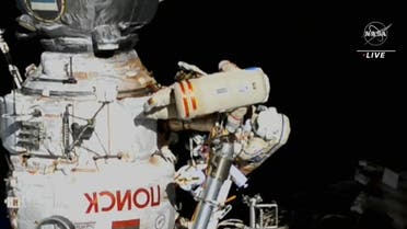 In this still image taken from a NASA TV broadcast, Expedition 67 Commander Oleg Artemyev (top) of Roscosmos, and Flight Engineer Samantha Cristoforetti of ESA, work outside the International Space Station on July 21, 2022, to continue outfitting the European robotic arm on the International Space Station’s Nauka laboratory. (Jose ROMER /NASA TV/AFP)