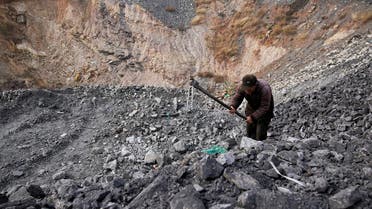 Zhang Tieliang 76, sifts through dunes of low-grade coal near a coal mine in Ruzhou, Henan province, China November 4, 2021. (File photo: Reuters)