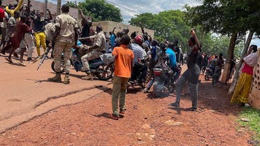 A crowd gathers around a man (not seen) suspected of taking part in thwarted “terrorist” attack after being beaten by a crowd, in front of the military base in Kati, Mali, on July 22, 2022. (AFP)
