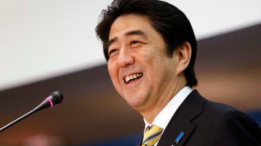 FILE - Japanese Prime Minister Shinzo Abe laughs while speaking at the Center for Strategic International Studies in Washington on Feb. 22, 2013. The assassination of former Japanese Prime Shinzo Abe has unearthed long-suspected, little-talked-of links between him and a religious group that started in South Korea but has spread its influence around the world. (AP Photo/Jacquelyn Martin, File)