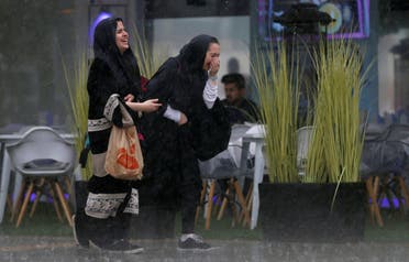 Women run for cover from rain in Riyadh, Saudi Arabia, February 16, 2017. (File photo: Reuters)