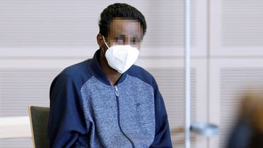 Defendant Abdirahman J. from Somalia arrives in a courtroom at the start of his trial after killing three people and injuring eleven others with a knife in June 2021 at Barbarossaplatz in Wuerburg, in Veitshoechheim, Germany. (Reuters)