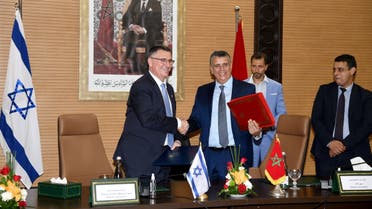 Moroccan Justice Minister Abdellatif Wehbe (R) and Israeli Justice Minister Gideon Saar (L), shake hands after signing an agreement in Rabat on July 26 , 2022. (AFP)