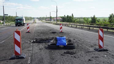 A picture taken on July 21, 2022 shows craters on Kherson’s Antonovsky (Antonivskiy) bridge across the Dnipro River caused by a Ukrainian rocket strike, amid the ongoing Russian military action in Ukraine. (AFP)