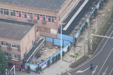 The building of Huanan seafood market, where the second floor remains open for optics stores, and where coronavirus believed to have first surfaced, almost a year after the start of the coronavirus disease (COVID-19) outbreak, in Wuhan, Hubei province, China December 8, 2020. Picture taken December 8, 2020. (Reuters)