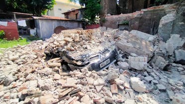 A car is buried under debris from a ruined old house in Vigan city, Ilocos Sur province north of Manila on July 27, 2022, after a 7.0-magnitude earthquake hit the northern Philippines. (AFP)
