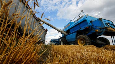 A combine loads a truck whith grain while harvesting wheat during Ukraine-Russia conflict in the Russia-controlled village of Muzykivka in the Kherson region, Ukraine July 26, 2022. REUTERS/Alexander Ermochenko