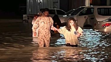 Authorities help people through floodwaters in this image shared by the Emirates News Agency WAM on Wednesday July 27, 2022. (WAM)