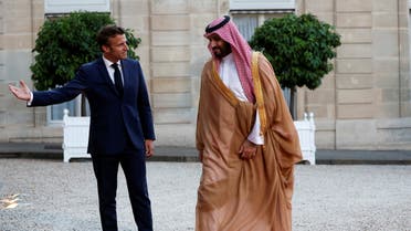 French President Emmanuel Macron welcomes Saudi Crown Prince Mohammed bin Salman ahead of a working dinner at the Elysee Palace in Paris, France, July 28, 2022. (Reuters)