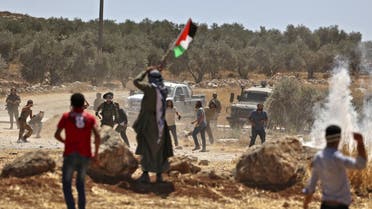 Palestinian demonstrators clash with Israeli forces following a protest against settlement expansion, in the village of al-Mughayer, east of Ramallah in the occupied West Bank, on July 29, 2022. (AFP)