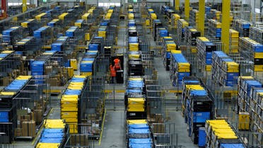 Employees handle packages at an Amazon logistic center in Mannheim, Germany, September 17, 2019. (Reuters)
