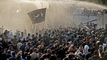 Security forces use a water cannon to prevent supporters of the Coordination Framework from entering the capital Baghdad's high-security Green Zone on August 1, 2022, during a counter-protest against Sadr's loyalists who have been occupying parliament. (AFP)