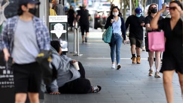 Shoppers walk through a retail district in the wake of coronavirus disease (COVID-19) lockdown restrictions being eased in Auckland, New Zealand, November 10, 2021. (Reuters)