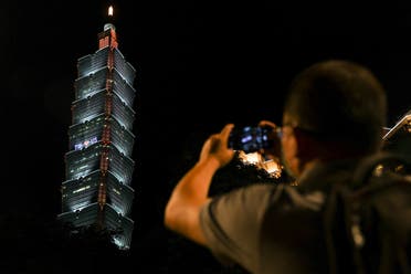A person takes a picture of a pro-US sign displayed on a tower ahead of Speaker Nancy Pelosi's expected visit, in Taipei, Taiwan August 2, 2022. (Reuters)