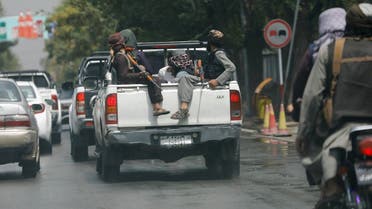 Taliban fighters carry a detained man in a military car in Kabul, Afghanistan, on August 2, 2022. (Reuters)