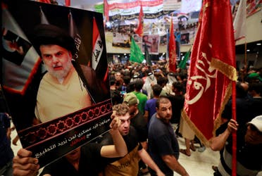 Supporters of Iraqi cleric Muqtada al-Sadr, protesting against a rival bloc's nomination for prime minister, continue their sit-in inside Iraq's parliament in the capital Baghdad's high-security Green Zone, on August 2, 2022. (AFP)