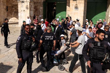 Israeli police stand by as Jews, including Israeli far-right lawmaker Itamar Ben Gvir, visit the compound known to Muslims as Noble Sanctuary and to Jews as Temple Mount in Jerusalem's Old City as Israel marks Tisha B'Av, the destruction of the First and Second Temples, August 7, 2022. (Reuters)