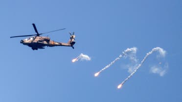 An Israeli Air Force Apache helicopter fires flares in the sky above the Israel-Gaza border August 7, 2022. (Reuters)