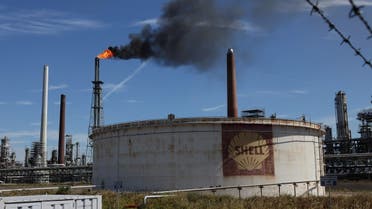 An oil tank of Shell is seen as a pilot flame burns atop a flare stack at the refinery of the Shell Energy and Chemicals Park Rheinland in Godorf near Cologne, Germany, on August 3, 2022. (Reuters)