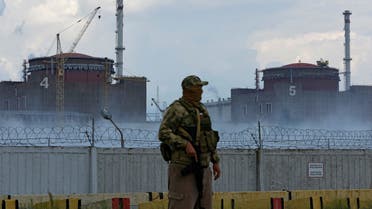 FILE PHOTO: A serviceman with a Russian flag on his uniform stands guard near the Zaporizhzhia Nuclear Power Plant in the course of Ukraine-Russia conflict outside the Russian-controlled city of Enerhodar in the Zaporizhzhia region, Ukraine August 4, 2022. REUTERS/Alexander Ermochenko/File Photo