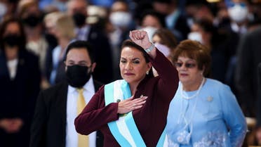Honduras new President Xiomara Castro raises her fist as she sings the national anthem during her swearing-in ceremony at the National Stadium in Tegucigalpa, Honduras, January 27, 2022. Picture taken January 27, 2022. REUTERS/Jose Cabezas