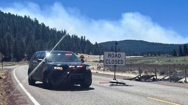 A police roadblock is placed, stopping people entering the area near Holman which is the northern edge of the Hermits Peak Calf Canyon wildfire, near Angostura, New Mexico May 9, 2022. (Reuters)