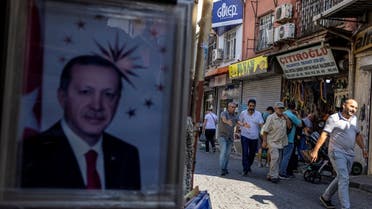 A portrait of Turkish President Recep Tayyip Erdogan is seen at the entrance of a shop as people walk along a street in Istanbul, Turkey, July 20, 2022. (File photo: Reuters) 