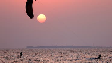 A kite-surfer is seen at Jumeirah Beach Residence in Dubai on August 17, 2021. (AFP)