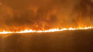 Flames and smoke rise during a fire in Hostens, as wildfires continue to spread in the Gironde region of southwestern France, in this screengrab taken from a handout video on August 9, 2022. (Reuters)