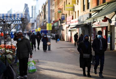 People walk past shops and market stalls, amid the coronavirus disease (COVID-19) outbreak, in east London, Britain, January 23, 2021. (Reuters)