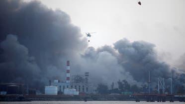 Helicopters throw water over the zone where fuel storage tanks exploded near Cuba's supertanker port in Matanzas, Cuba, August 9, 2022. (Reuters)