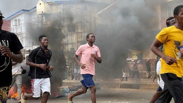 People run away during an anti-government protest, in Freetown, Sierra Leone, August 10, 2022 in this picture obtained from social media. (Social Media via Reuters)