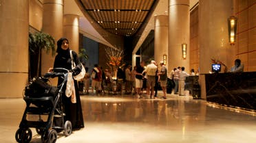 A woman walks with a baby stroller in a hotel lobby in Dubai, March 30, 2010. (File photo: Reuters)