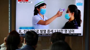 People watch a TV broadcasting a news report on the coronavirus disease (COVID-19) outbreak in North Korea, at a railway station in Seoul, South Korea, May 17, 2022. (Reuters)