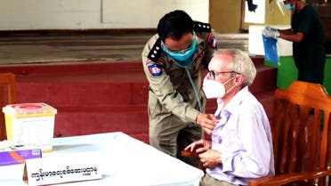 This handout photo from the state-run Myanmar News Agency (MNA) taken on July 28, 2021 and received on July 29 shows Sean Turnell, a detained Australian adviser to Myanmar's deposed leader Aung San Suu Kyi, getting vaccinated against the Covid-19 coronavirus in Insein prison in Yangon. (AFP)