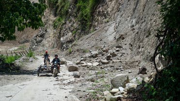 Motorists pass by fallen rocks in the aftermath of an earthquake in Bucloc, Abra province, Philippines, July 29, 2022. REUTERS/Lisa Marie David