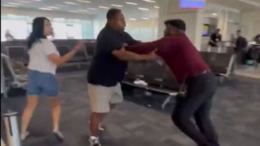 A Spirit Airline representative fighting with a female passenger in a US airport. (Screengrab)