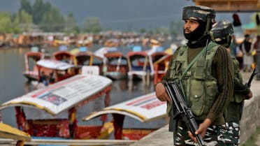 India's Central Reserve Police Force (CRPF) personnel stand guard on the banks of Dal Lake, a famous tourist attraction, in Srinagar May 26, 2022. (Reuters)