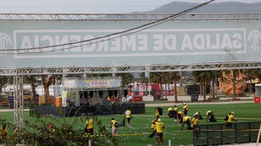 Staff members clean the venue of Medusa Festival, an electronic music festival, after high winds caused part of a stage to collapse, in Cullera, near Valencia, Spain, August 13, 2022. (Reuters)