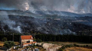 A resident watches the progression of a wildfire in Linhares, Celorico da Beira in Portugal on August 11, 2022. (AFP)