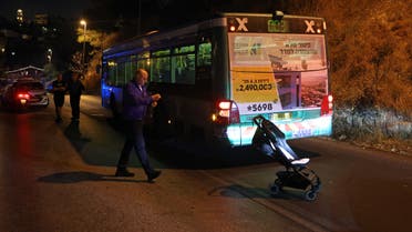 Israeli security inspect a bus after an attack outside Jerusalem's Old City, August 14, 2022. Seven people were injured, two of them critically, after a shooting attack on a bus in Jerusalem's Old City, Israeli police and the national emergency medical services said early August 14, 2022. (AFP)