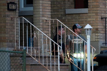 A New Jersey police officer and a plain-clothed police officer exit the building where alleged attacker of Salman Rushdie, Hadi Matar, lives in Fairview, New Jersey, US, August 12, 2022. (Reuters)