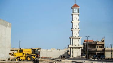 A man walks past the new clock tower in the Syrian Kurdish town of Kobane, also known as Ain al-Arab, in the north of Aleppo governorate on February 25, 2021, a monument marking the city's resistance to ISIS. (AFP)