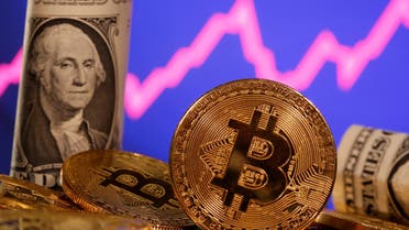 A representation of virtual currency bitcoin and a U.S. one dollar banknote are seen in front of a stock graph in this illustration taken January 8, 2021. (File Photo: Reuters)