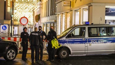 Police stand near Christmas illuminations as they secure a street near one of the scenes where a car drove into pedestrians the center of Trier, southwestern Germany, on December 1, 2020. (AFP)