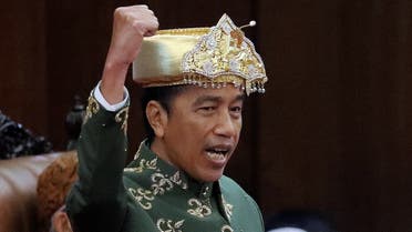 Indonesian President Joko Widodo, wearing traditional attire from Bangka Belitung Islands, shouts ‘Merdeka’ or ‘Freedom’ while delivering his State of the Nation Address ahead of the country’s Independence Day at the parliament building in Jakarta, Indonesia, on August 16, 2022.  (Reuters)