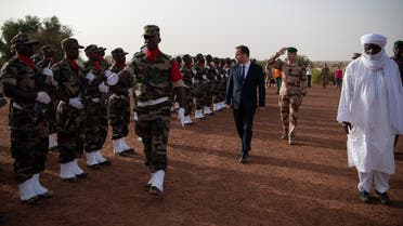 French Armed forces Minister Sebastien Lecornu (CL), France’s Chief of the Defense Staff Thierry Burkhard (C) and Niger Minister of National Defense Alkassoum Indatou (R) review troops as they arrive at the Ouallam’s military base on July 15, 2022. (AFP)