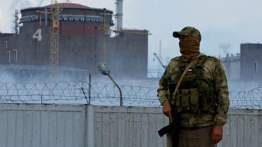 A serviceman with a Russian flag on his uniform stands guard near the Zaporizhzhia Nuclear Power Plant in the course of Ukraine-Russia conflict outside the Russian-controlled city of Enerhodar in the Zaporizhzhia region, Ukraine August 4, 2022. (Reuters)