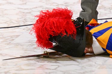 A Swiss Guard lies on the floor after he fainted during the Pope's weekly general audience on August 17, 2022 at Paul-VI hall in The Vatican. (AFP)