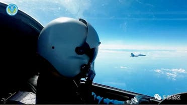 An Air Force pilot navigates an aircraft next to a fighter jet under the Eastern Theatre Command of China's People's Liberation Army (PLA) during military exercises in the waters and airspace around Taiwan, at an undisclosed location August 9, 2022 in this handout image released on August 10, 2022. Eastern Theatre Command/Handout via REUTERS ATTENTION EDITORS - THIS IMAGE WAS PROVIDED BY A THIRD PARTY. MANDATORY CREDIT. NO RESALES.